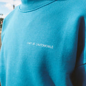 SEATING IN A BLUE DESIGN CREWNECK