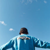 SEATING IN A BLUE DESIGN CREWNECK